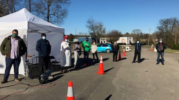 Drive through COVID testing station with staff