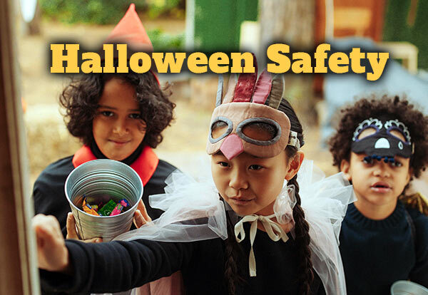 Halloween Safety. Three children are knocking on a door to trick-or-treat.