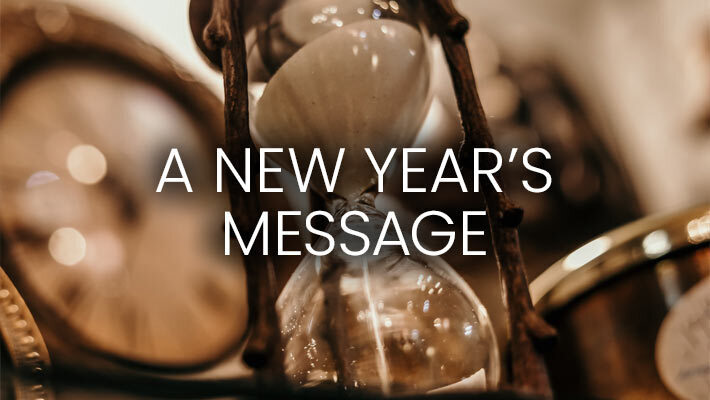The words A New Year's Message with an hourglass and clock in the background.