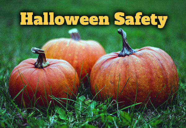 Three pumpkins in grass with the words Halloween Safety.